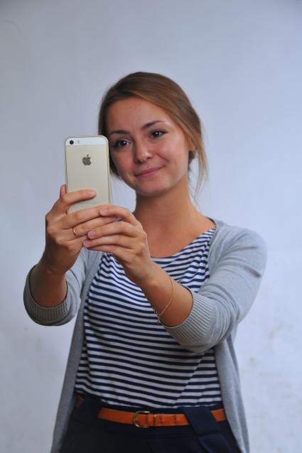 Девушка делает селфи на iPhone.