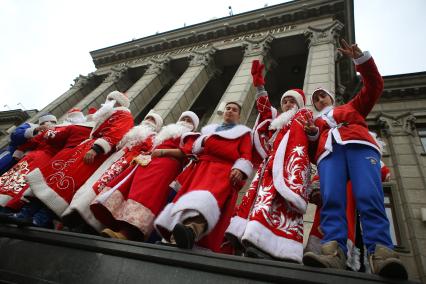 Дед морозы фотографируются у здания ЗСК во время парада Дедов Морозов в Краснодаре