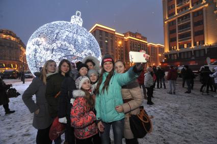 Манежная площадь. На снимке: девушки делают селфи на фоне гигантского елочного шара высотой 11,5 метра.