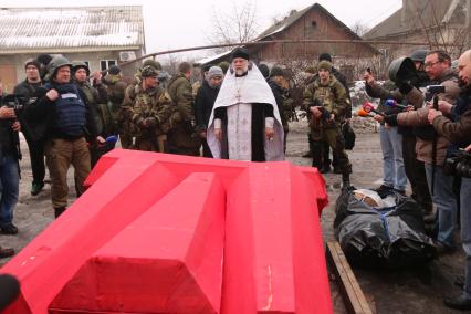 Донецк. Священник отпевает тела украинских военных, погибших в аэропорту.