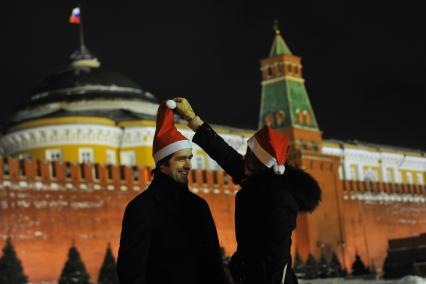 Празднование Старого Нового года в Москве. На снимке: молодые люди в шапках Деда Мороза на Красной площади.