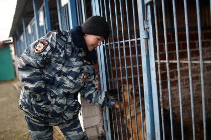 Девушка-полицейский кинолог с своей служебной собакой в Уральском кинологическом центре