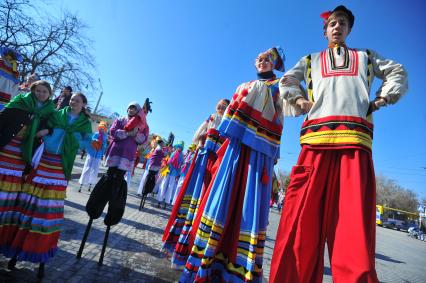 Евпатория. Широкая Масленица. Ряженые ходулисты идут по улице.