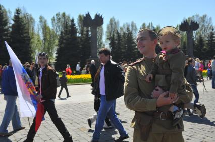 Москва. Мужчина с ребенком на руках в военной форме времен ВОВ во время праздничных мероприятий, посвященных 69-й годовщине Победы в Великой Отечественной войне на Поклонной горе.