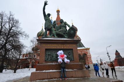 День Святого Валентина в Москве. Юноша с плюшевым медведем у памятника Минину и Пожарскому на Красной площади.