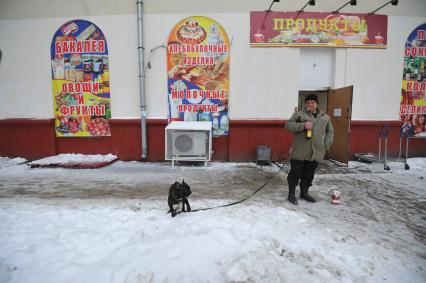 Москва. Мужчина выгуливает собаку.