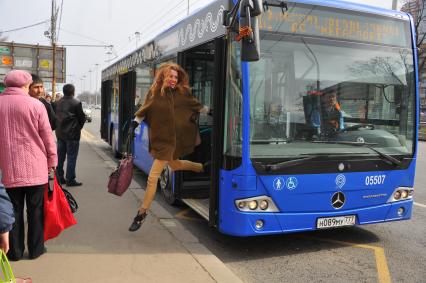 Москва. Счастливая девушка выходит из автобуса.