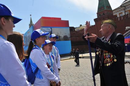 Москва. Ветеран общается с волонтерами после Парада на Красной площади, в честь 70-летия Победы в Великой Отечественной войне.