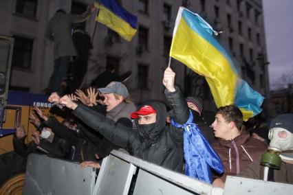 Евромайдан. Активисты Евромайдана атакуют сотрудников спецподразделения `Беркут`, не дающих им прорваться к зданию администрации президента на Банковой улице.