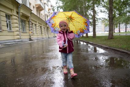 Маленький ребенок под зонтиком во время прогулки. Екатеринбург