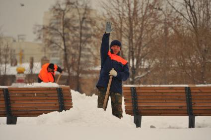 Последствия метели в Москве. Дворник убирает снег.