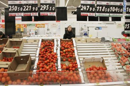 Нижний Новгород. Девушка выбирает овощи в супермаркете.
