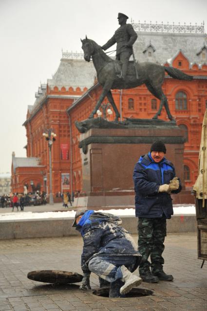 Москва. Бригада слесарей аварийно-восстановительных работ   проводят технический осмотр канализационной сети на площади Революции.