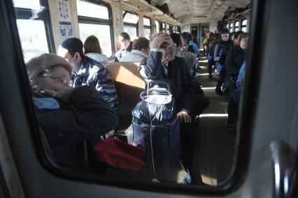 Московская область.  Пассажиры в пригородной электричке.