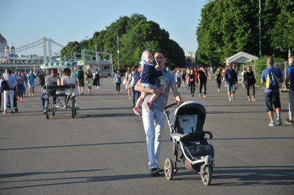 Москва.    Мужчин с ребенком гуляет в Парке Горького.