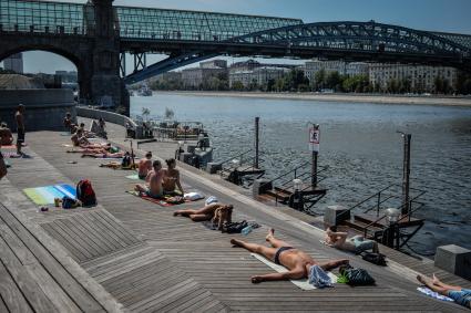 Москва. Горожане отдыхают на Пушкинской набережной рядом с Пушкинским мостом в парке Горького.