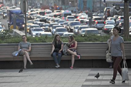 Москва. Девушки отдыхают на скамейке на Триумфальной площади.