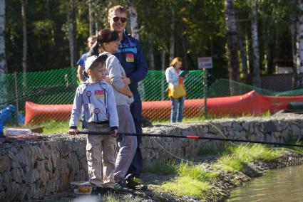 Екатеринбург. Ребенок с родителями ловит рыбу на фестивале семейной рыбалки