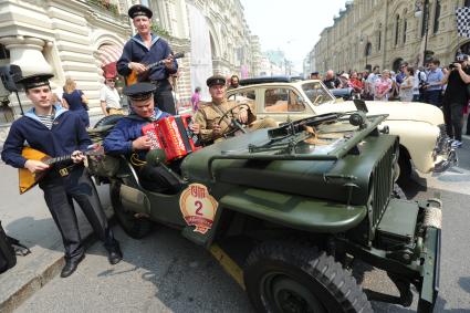 Москва.  Участники  на армейском автомобиле `Виллисе` (Willys MB) перед стартом ралли классических автомобилей `ГУМ-Авторалли` у ГУМа.