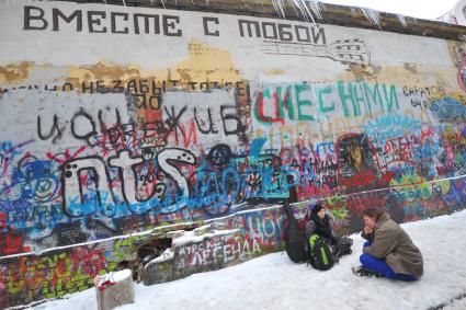 Москва.  Уличные музыканты  сидят у стены памяти Виктора Цоя на  Старом Арбате.