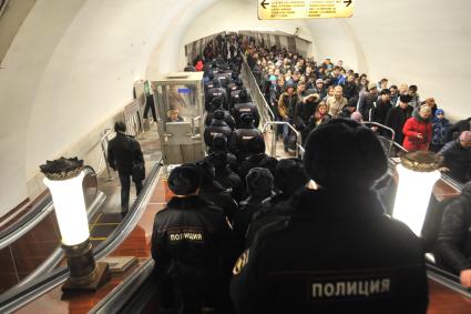 Москва.  Сотрудники полиции  на эскалаторе на станции метро `Октябрьская`.