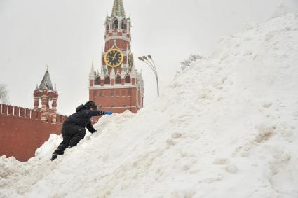 Москва. Мальчик играет в снегу на Васильевском спуске.