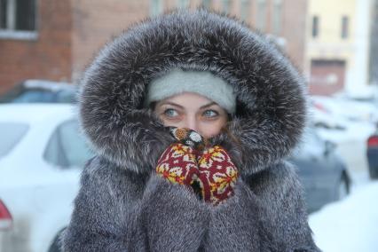 Нижний Новгород. Девушка на морозе закутала лицо  в меховой воротник .