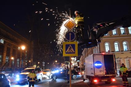 Москва. Сотрудники Центра организации дорожного движения (ЦОДД) во время замены дорожных знаков на знаки уменьшенного размера на улице Большая Никитская.