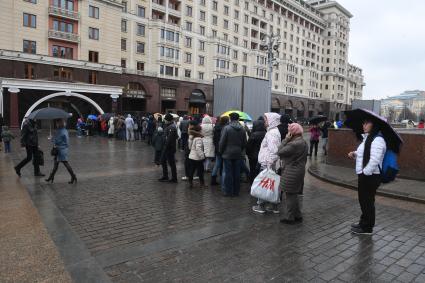 Москва.  Посетители стоят в очереди в музей археологии Москвы на Манежной площади.