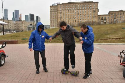 Москва. Сотрудники проката помогают корреспонденту `Комсомольской правды ` Павлу Клокову освоить гироскутер.