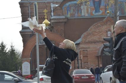 Тула. Женщина выпускает в небо белых голубей в честь праздника Благовещения Пресвятой Богородицы.