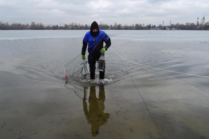 Москва.   Водолаз чистит  озеро Белое от мусора в районе Косино-Ухтомское.