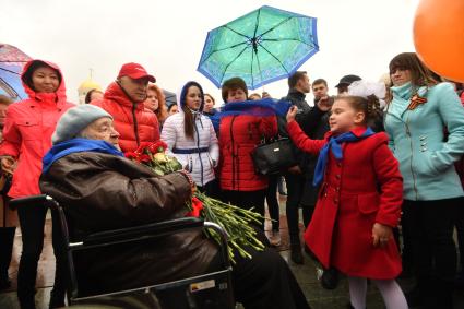 Москва. Девочка поздравляет ветерана   Великой Отечественной Войны во  время празднования Дня Победы на Поклонной горе.