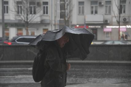 Москва. Мужчина во время урагана на одной из улиц города.