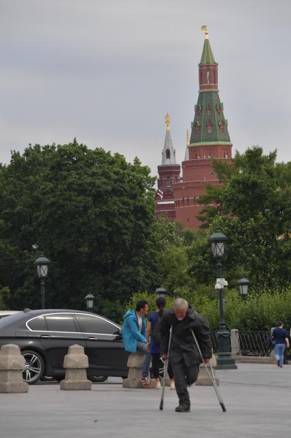 Москва. Мужчина на костылях у Александровского сада.