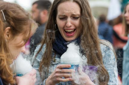 Санкт-Петербург.  Девушки держат в руках стаканчики с напитком  на научно-популярном  фестивале Geek Picnic в Пулковском парке.