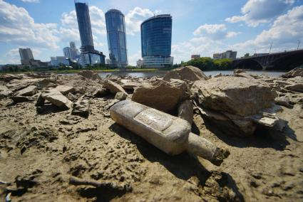 Екатеринбург. Бутылка на дне городского пруда обмелевшего из-за сброса воды