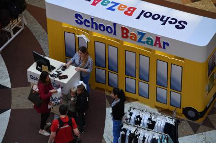 Москва. Родители покупают школьную форму для своих детей к началу учебного года на школьной ярмарке в `Центральном детском магазине`.