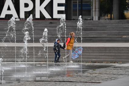 Москва.Пешеходы у фонтанов  в парке `Музеон`  на Крымской набережной.