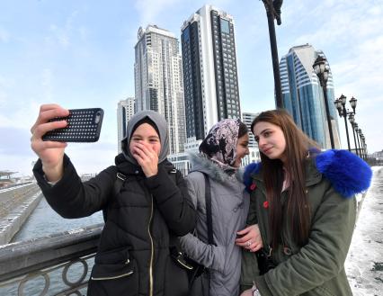 Чечня, Грозный. Девушки фотографируются на улице города.