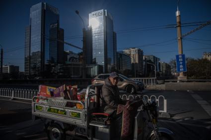 Китай, Пекин. Грузовой мотоцикл (трицикл) на улице города.