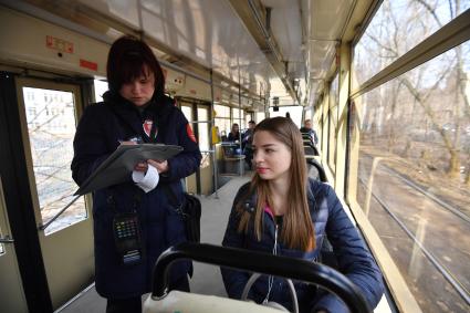 Москва.  Контролер выписывает штрафную квитанцию пассажирке за безбилетный проезд.