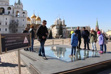 Москва. Туристы на Ивановской площади Кремля у архиологического окна .