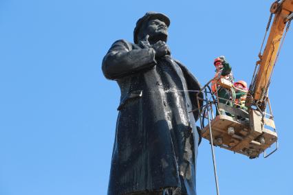 Красноярск.  Сотрудницы коммунальных служб моют памятник  В.И. Ленину на одной из улиц города.