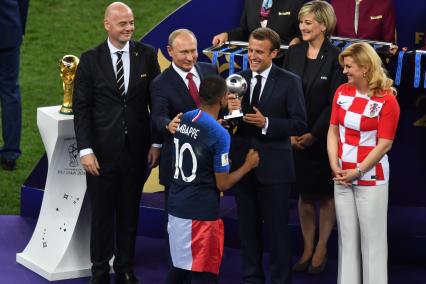 Москва. Президент FIFA Джанни Инфантино, президент РФ Владимир Путин, президент Франции Эммануэль Макрон (слева направо) и президент Хорватии Колинда Грабар-Китарович (справа) во время церемонии награждения после финального матча чемпионата мира по футболу - 2018 между сборными командами Франции и Хорватии на стадионе `Лужники`.