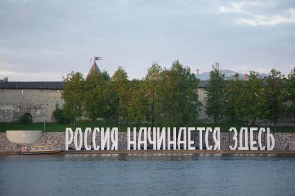 Псков.   Надпись `Россия начинается здесь` на набережной у стен Псковского Крома.