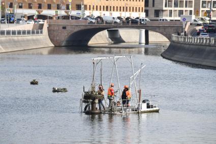 Москва. Рабочие убирают на зиму плавучие фонтаны Водоотводного канала.