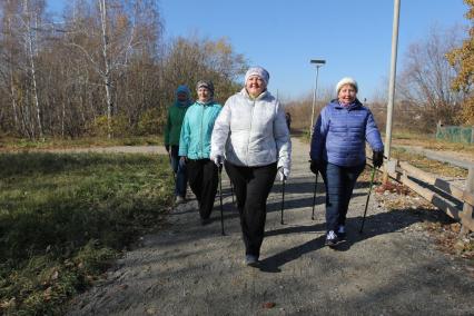 Иркутск. Горожане во время скандинавской ходьбы в парке.