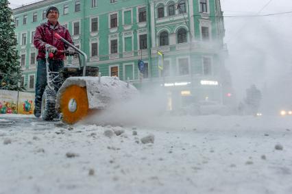 Санкт-Петербург. Дворник убирает снег на улице.