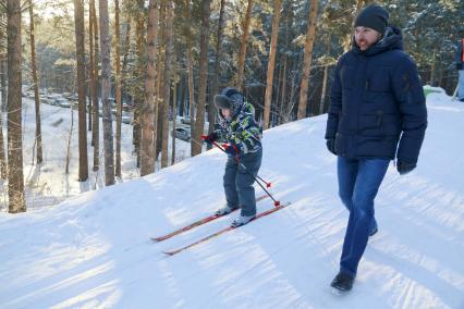 Барнаул.  Мужчина с ребенком на лыжной прогулке.